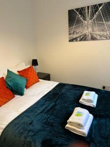 a bedroom with a bed with towels on it at Watergall Lodge in Peterborough