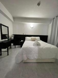 Una cama o camas en una habitación de HOTEL BLUE COSTA Panama