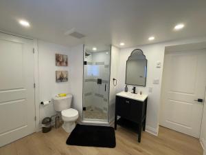 a bathroom with a shower and a toilet and a sink at Cozy Cottage Style House in Kitchener