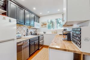 a kitchen with stainless steel appliances and blue cabinets at Modern Ski Retreat #C7 in Avon