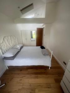 a bedroom with a large white bed in a room at N8, Modern 2 bedroom Apartment in London