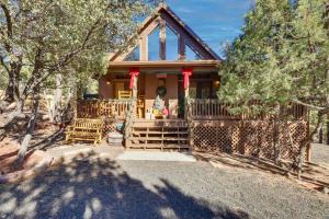 a house with a fence in front of it at Scenic Arizona Cabin Rental Near Show Low Lake! in Show Low