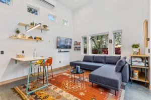 a living room with a couch and a table at Enchanting & Newly Built NoHo 1 BDR Loft with AC! in Flagstaff