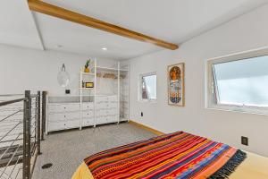 a bedroom with white walls and a bed and a window at Enchanting & Newly Built NoHo 1 BDR Loft with AC! in Flagstaff