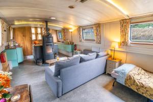 a living room in an rv with couches and a stove at Off-Grid Living on Spacious Widebeam in Bath