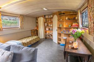 a living room with a couch and a table at Off-Grid Living on Spacious Widebeam in Bath