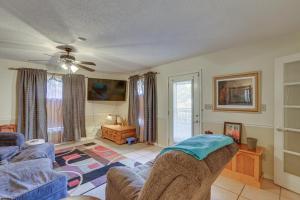 a living room with a couch and a table at Rustic Thomasville Home with Deck 2 Mi to Downtown! in Thomasville