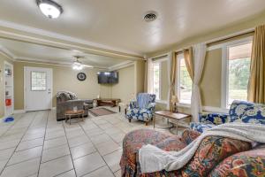 a living room with couches and a tv at Baton Rouge Vacation Rental with Yard 10 Mi to LSU! in Baton Rouge