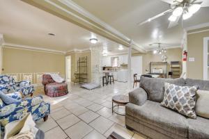 a living room with two couches and a kitchen at Baton Rouge Vacation Rental with Yard 10 Mi to LSU! in Baton Rouge