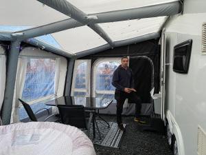 een man in de binnenkant van een RV bij RostrevorValley Caravan Experience Private HotTub in Rostrevor