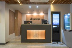 an office lobby with a fireplace in the middle at Hotel Centro Stay in Incheon