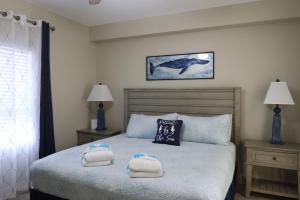 a bedroom with a bed with towels on it at Laketown Wharf 1233 luxury condo in Panama City Beach