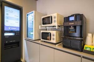 a counter with microwaves and appliances on it at Hotel Centro Stay in Incheon