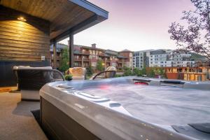 a large hot tub sitting on top of a balcony at FREE Daily Maid Service! in Park City