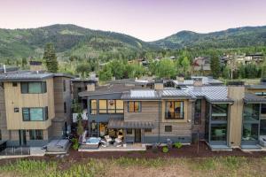 an aerial view of a house with mountains in the background at FREE Daily Maid Service! in Park City