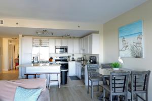 a kitchen and living room with a table and chairs at Laketown Wharf 1233 luxury condo in Panama City Beach