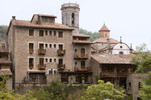 an old stone building with a tower and turrets at Casa Can Rufo de Rupit in Rupit