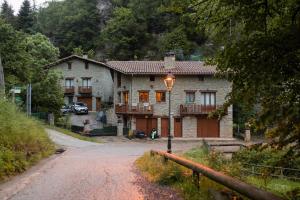 a house with a street light on the side of a road at Casa Can Rufo de Rupit in Rupit