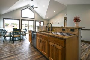 a kitchen with a sink and a dining room at New Lisbon Vacation Rental Near Castle Rock Lake in New Lisbon