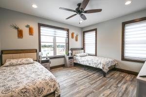 a bedroom with two beds and a ceiling fan at New Lisbon Vacation Rental Near Castle Rock Lake in New Lisbon