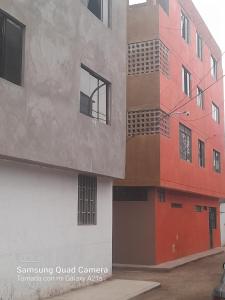 a building that is painted in different colors at Kely2 Tercer Piso in Lima