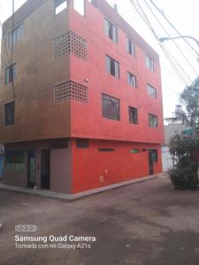 a red building with a red at Kely3 Cuarto Piso in Lima