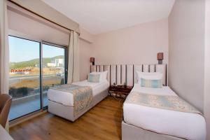 Postel nebo postele na pokoji v ubytování Ramada By Wyndham Soma
