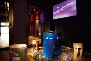 a room with two stools and a tv on the wall at Pentahotel Prague in Prague