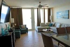 a living room with a couch and chairs at AQUA 1504 Beachfront condo with Free Beach Chairs in Panama City Beach
