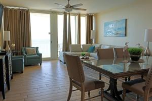 a living room with a table and a couch at AQUA 1504 Beachfront condo with Free Beach Chairs in Panama City Beach