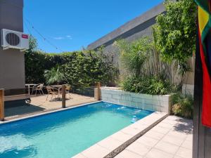 a swimming pool in the backyard of a house at SLB Apart - Duplex in San Luis