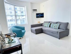 a living room with a couch and a chair at 2 BEDROOM ON THE BEACH ! in Miami Beach