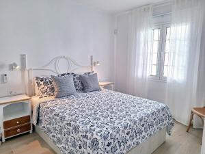 a white bedroom with a bed and a window at Casa Limoncello in Puerto del Carmen +9 photos
