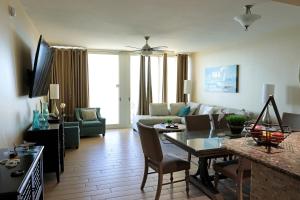a living room with a couch and a table at AQUA 1504 Beachfront condo with Free Beach Chairs in Panama City Beach