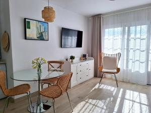 a living room with a glass table and chairs at Casa Limoncello in Puerto del Carmen