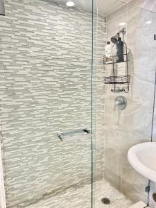 a bathroom with a glass shower with a sink at 2 BEDROOM ON THE BEACH ! in Miami Beach