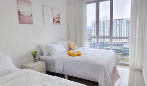 a bedroom with two beds with a teddy bear on it at Home Cinema - BM City Centre - 4km to Icon City at The Metropol Muji Style Apartment in Bukit Mertajam