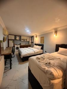 ein Hotelzimmer mit 2 Betten und einem Schreibtisch in der Unterkunft AWWA APART HOTEL in Istanbul