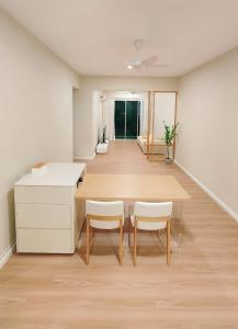 a dining room with a table and chairs in a room at Home Cinema - BM City Centre - 4km to Icon City at The Metropol Muji Style Apartment in Bukit Mertajam +21 photos