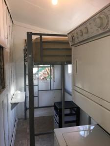 a small kitchen with a bunk bed in a tiny house at DTLA Oasis Private Bedroom with Exclusive Laundry - Steps to the Heartbeat of LA in Los Angeles