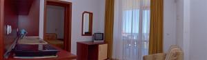 a bathroom with a sink and a tv on a counter at Svetlana Hotel in Byala