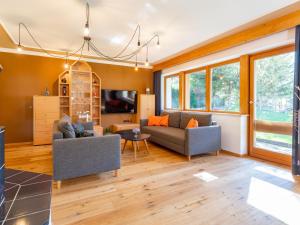 a living room with two couches and a tv at Familienchalet Kitzblick in Kaprun