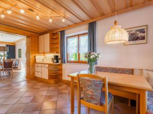 a kitchen and dining room with a table and chairs at Familienchalet Kitzblick in Kaprun
