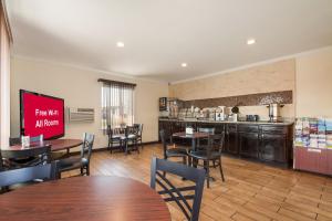 a restaurant with tables and chairs and a kitchen at Red Roof Inn Santee in Santee