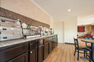 a kitchen with a counter with a table and chairs at Red Roof Inn Santee in Santee