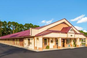 a building with a purple roof on a street at Red Roof Inn Santee in Santee