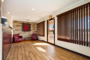 a hallway with a waiting room with chairs and a door at Red Roof Inn Santee in Santee