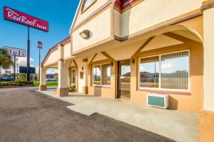 a hotel with a sign on the side of a building at Red Roof Inn Santee in Santee