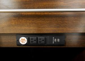 an alarm clock on the side of a wooden table at Red Roof Inn Santee in Santee
