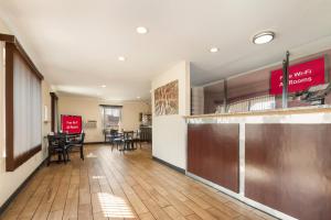 a lobby with a waiting area with tables and chairs at Red Roof Inn Santee in Santee